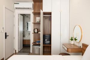 a bedroom with a bed and a sink and a mirror at RAINBOW Motel 3 in Phú Quốc