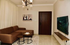a living room with a couch and a table at Four Stays Khobar in Al Khobar