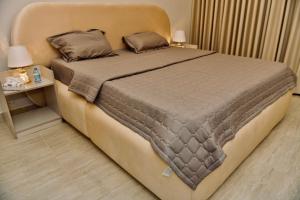 a bedroom with a large bed with two pillows at Four Stays Khobar in Al Khobar