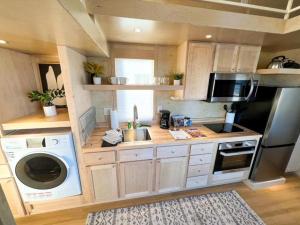 a kitchen with a sink and a washing machine at Secluded Tiny House Oasis in Grand Junction: Nature's Perfect Glamping Hideaway in Colorado in Grand Junction