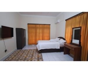 Postel nebo postele na pokoji v ubytování OYO 94930 Yetelu Guest House + 18 fotografií