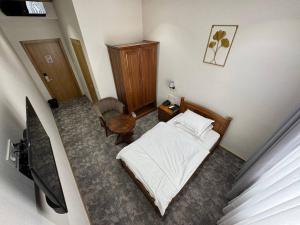 a small bedroom with a bed and a chair at Muhammad in Andizhan