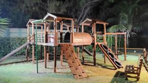 un parco giochi in legno con scivolo e struttura per il gioco di Manhattan Beach Riviera 2 Terreo ad Aquiraz