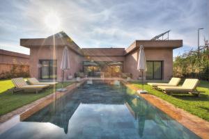 a house with a swimming pool in the yard at Villa Marrakech in Marrakesh