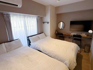 Giường trong phòng chung tại 最大7名宿泊 名古屋駅近地下鉄徒歩5分 2室貸し切り 無料wifi TypeC