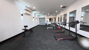 a gym with several treadmills and cardio machines at The Select Inn Penrith in Penrith