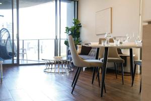 a dining room with a table and chairs at Southbank exceptional View with huge balcony High Lvl Suite style APT in Brisbane