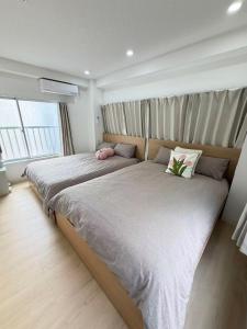 Ένα ή περισσότερα κρεβάτια σε δωμάτιο στο TOMI Hotel 神保町301