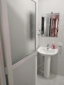 a bathroom with a glass shower door and a sink at Solace Transit Villa in Katunayake +60 photos