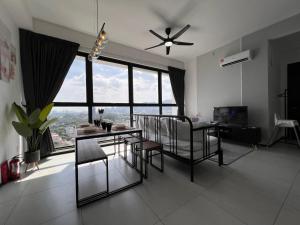 a living room with a dining room table and chairs at Georgetown Urban Family & Baby-Friendly Home with Skypool Seaview in Jelutong