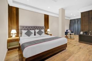 a bedroom with a large bed and a living room at Hotel Aerotech Near Delhi Airport in New Delhi +20 photos