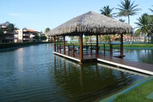 a pier with a hut on the water at Aquaville Aquiraz Hotel in Aquiraz