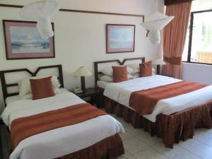 a hotel room with two beds in a room at Indiana Beach Apartments in Bamburi