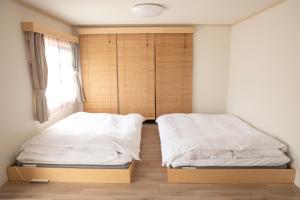 Postel nebo postele na pokoji v ubytování Guesthouse Life Field