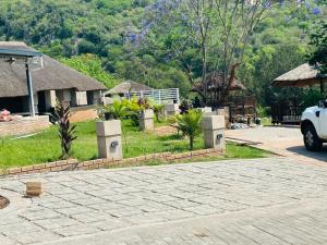 a house with a yard with a driveway at Siyaya’s Guest Palace in Jozini