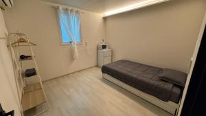 a small bedroom with a bed and a ladder at SRR Stay in Gwangmyeong