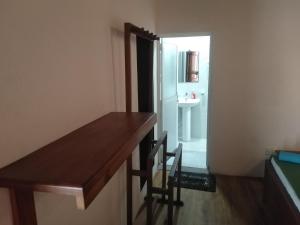 a room with a table and a bathroom with a sink at Solace Transit Villa in Katunayake