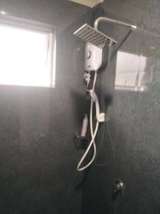 a shower in a bathroom with a window and a shower at Solace Transit Villa in Katunayake