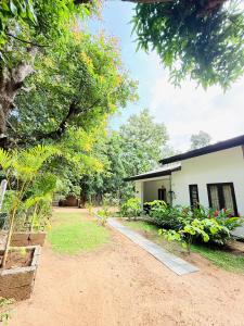 a view of a house and a yard at Sigiri Bloom Villa in Sigiriya