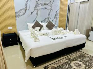 a large bed with white decorations on it in a room at Villaasa in Shaviyani Atoll +11 photos