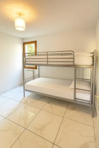a bedroom with bunk beds in a room with a tile floor at Appartement t3 à Montpellier in Montpellier