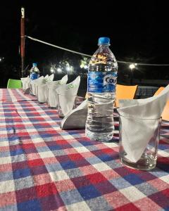 a bottle of water sitting on top of a table at Saatvik Stay 2 - A Dormitory Stay in Kushālnagar