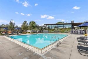 einen Pool in einem Resort mit Stühlen und Sonnenschirmen in der Unterkunft #Marbella Lane - Chic Stay In Prime Irvine Area in Irvine