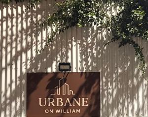 a sign on a fence that reads insurance on william at Urbane on William in Rockhampton