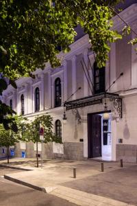 a large white building with a door in front of it at Palacio de los Duques Gran Meliá - The Leading Hotels of the World in Madrid