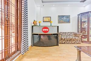 a living room with aku sign on the fireplace at Hotel O Delhi Heights 2 Home stay in New Delhi