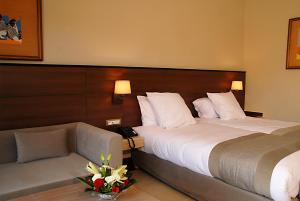 a hotel room with a bed and a couch at Oasis Palm Hotel in Guelmim +38 photos