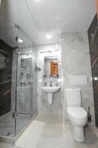 a bathroom with a toilet and a sink and a shower at Bogishamol Hotel in Andijan +57 photos