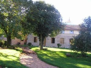 a house with trees in front of a yard at Casa Grande da Capellania in Padrón