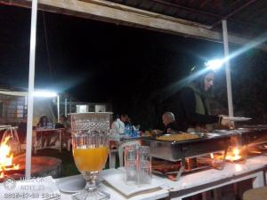 a bar with a table with a glass of beer at Homebase gardens guesthouse in Nakuru