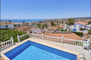 a swimming pool on top of a house at Villa with Private Pool and Gorgeous View in Caleta De Velez