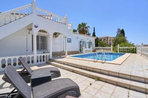 a villa with a swimming pool and a house at Villa with Private Pool and Gorgeous View in Caleta De Velez