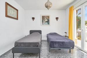 a bedroom with two beds and a window at Villa with Private Pool and Gorgeous View in Caleta De Velez +63 photos