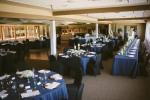 a room filled with tables and chairs with blue linens at Ridgemark Golf Club and Resort in Hollister