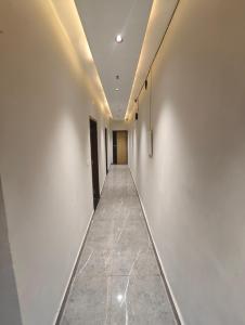 a corridor of an office with white walls and a long hallway at Hotel Elev11 in Zirakpur