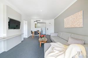 a living room with a couch and a table at Darwin Harbourside Escape - Two Adjacent King Suites in Darwin