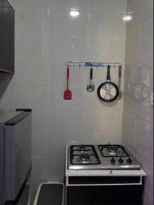 a kitchen with a stove and a sink in it at Maas Nightingale Apartments in Port Harcourt