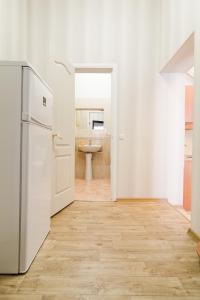 a kitchen with a white refrigerator and a bathroom at Best Apartment in the city centre in Odesa