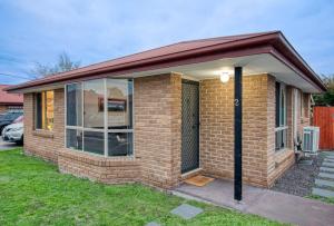 a small brick house with a large window at Sorell Gateway Villa in Sorell