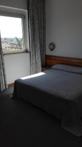 Postel nebo postele na pokoji v ubytování Hotel Excelsior