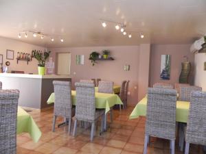 a dining room with a table and chairs at Hotel Les Pins in Hourtin