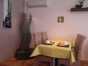 a dining room with a table and a vase at Hotel Les Pins in Hourtin