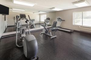 a gym with several treadmills and cardio machines at Wingate by Wyndham Lincoln Airport East I-80 in Lincoln