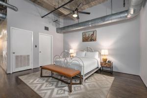 a bedroom with a white bed and a table at Reside Houston Downtown, a Wyndham Residence in Houston +60 photos