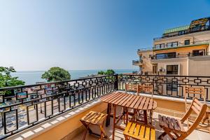 金沙Beach Front Suites SEAVIEW BG的带桌椅和海景的阳台
