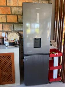a refrigerator sitting in a kitchen next to a counter at lodge3a in Ponta do Ouro +7 photos